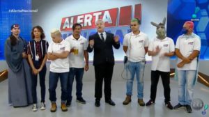 Sikêra Jr. posa ao lado de seu elenco no cenário do Alerta Nacional (foto: reprodução/RedeTV!)