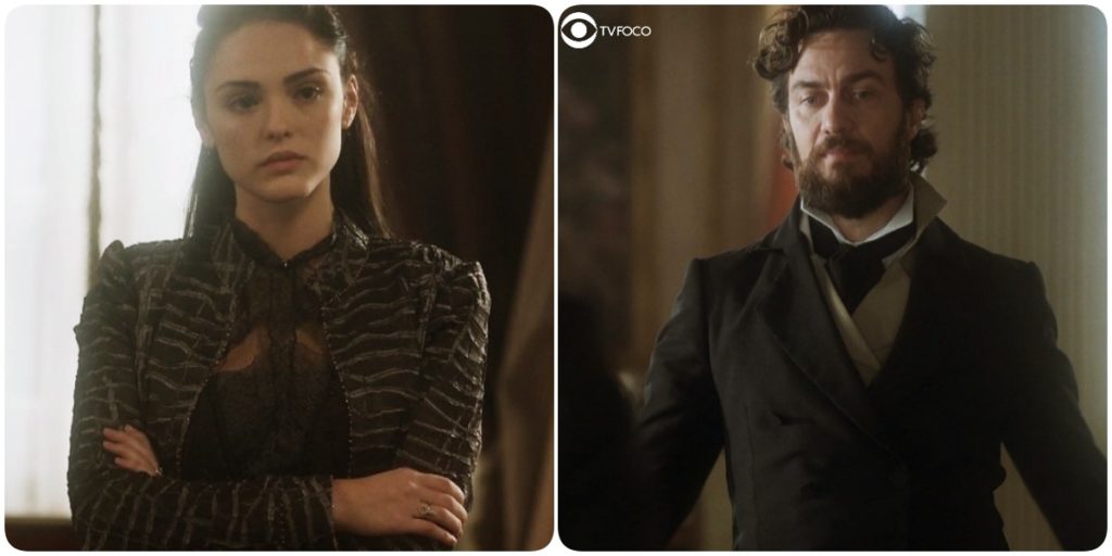 Foto montagem da novela de época Novo Mundo onde Anna, mulher branca de vestido escuro, está de braços cruzados e Thomas, homem branco e de barba castanha, está olhando para baixo com trajes de época